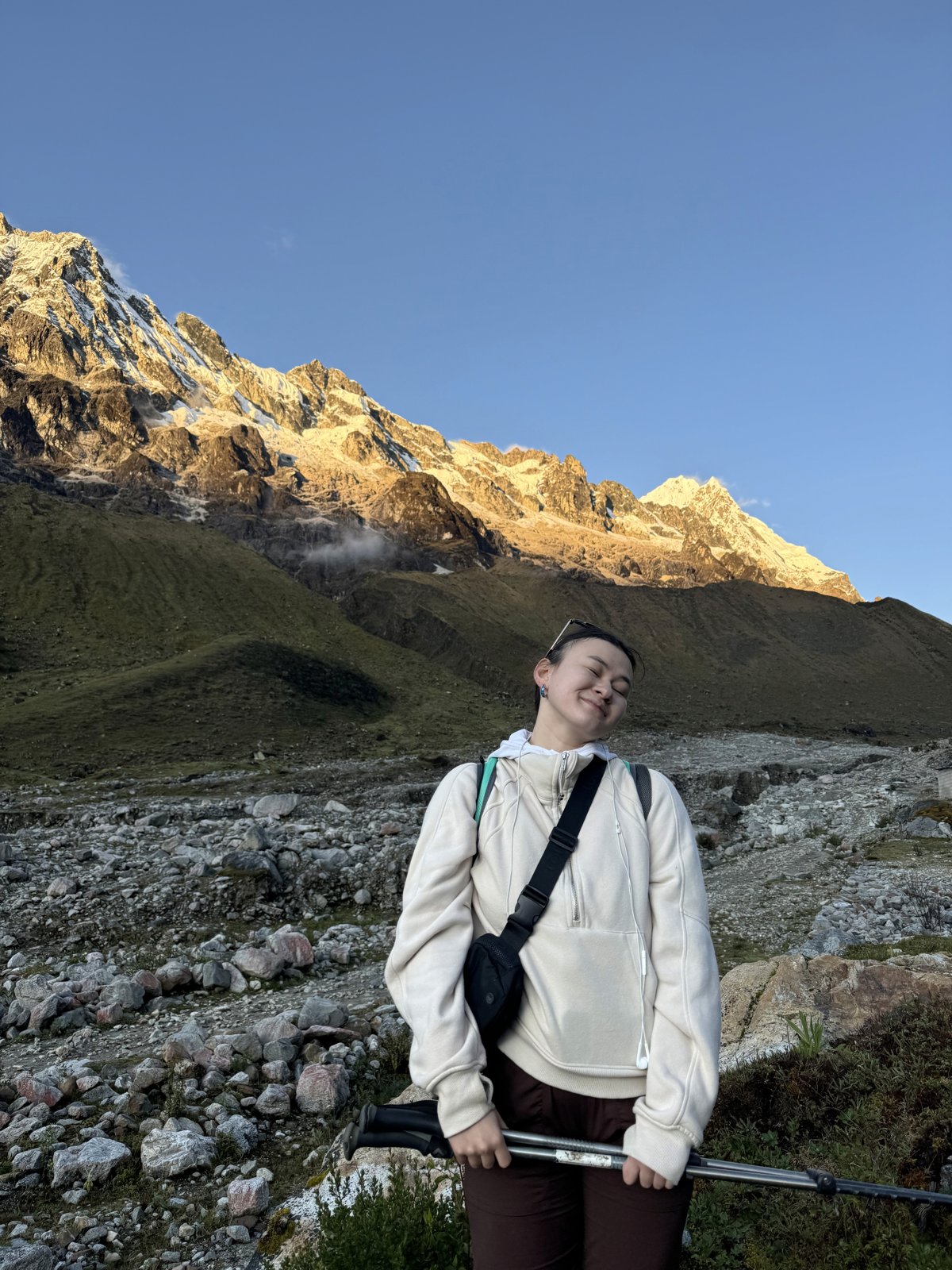Ksenia Li smiling in front of a mountain landscape